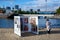 A woman looks at a Photoville 2020 exhibit in Brooklyn Bridge Park.