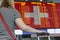 Woman looks at the scoreboard at the airport. Select a country Switzerland for travel or migration