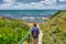 Woman looks at sea from awesome garden