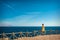 Woman looks at the sea and the island of Tiran