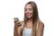 Woman looks at the smartphone screen and smiles