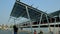 A woman looks up at overhead solar shade structures