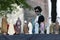 Woman looks at virgin mary statues on open air market in bruges