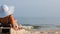 Woman on a lounger in the hat