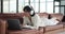 Woman Lounging on Sofa with Headphones and Browsing Laptop