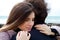 Woman in love hugging strong husband in front of ocean