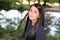 woman with lovely smile standing on river lake park promenade in summer looking at the camera