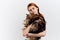 Woman loves pets hugging a cat on a light background