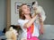 A woman lovingly looks at a beaver Yorkshire Terrier dog holding it in her hands