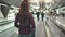 Woman with luggage stand on speedwalk at airport