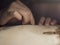 woman luthier maker carving the violin plate with thumb plane in the workshop with dim light