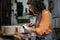 woman luthier making guitars in her musical instrument workshop