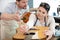 woman luthier repairing guitar in instrument workshop