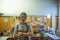 Woman luthier small business owner portrait, in her musical instrument workshop