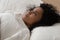 Woman lying in bed cannot fall asleep suffers from insomnia