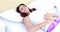 Woman lying on bed with stomach pain