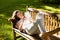 Woman lying on bench and using digital tablet in garden