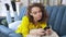 Woman lying on comfortable sofa with smartphone in hands