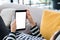 Woman lying down on sofa using tablet and listening music at home.Mock up screen for display of design or content