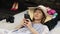 Woman lying on floor text messaging on cell phone