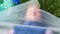 Woman is lying inside a plastic bag. Plastic pollution