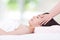 Woman lying on a massage table in a health spa