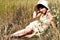 Woman lying on summer field among flowers