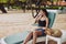 woman lying sunbed beach recreation lifestyle sea ocean smiling sand resort