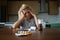 Woman lying at the table, depressed, lonely, sick, despondent, unhappy, suffering, among pills