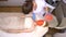 Woman lying on the table with the face completely covered with organic beauty mask, the professional cosmetologist