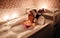 Woman lying in tub doing hydrotherapy treatment