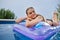 Woman lying on water matrass in the pool