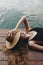 Woman lying on a wooden deck by the lake