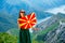 Woman with macedonian flag on the top of mountain