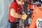 Woman machinist working with wrench of a farm machine