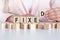 Woman made word FIXED with wooden blocks