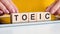 Woman made word toeic with wooden blocks, concept