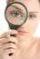 Woman with magnifier lens on eye