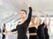 Woman maintaining third position at ballet barre at group rehearsal