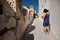 A woman make photos of a cat in the street