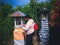 Woman Make Simple Offerings On Small Balinese Farming Shrines Of Agricultural Area At Village