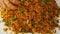 Woman makes turkish lentil patties, kneading a mixture of boiled lentils and bulgur on the tray