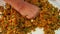 Woman makes turkish lentil patties, kneading a mixture of boiled lentils and bulgur on the tray