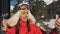 A woman makes a video call on smartphone in the cabin ski lift.