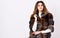 Woman makeup and hairstyle posing mink or sable fur coat. Winter elite luxury clothes. Female brown fur coat. Fur store