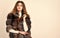 Woman makeup and hairstyle posing mink or sable fur coat. Winter elite luxury clothes. Female brown fur coat. Fur store