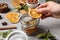 Woman making aromatic potpourri at grey table, closeup