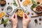 Woman making aromatic potpourri at grey table, top view