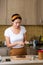 Woman making avocado peanut butter toast for a healthy breakfast