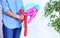 Woman making balloon figure on blurred background, closeup.